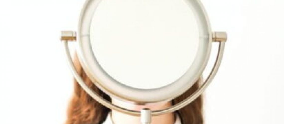 woman in white long sleeve shirt holding magnifying glass